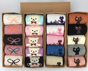 Close-up of assorted Christmas wool socks with cartoon patterns in a kraft gift box