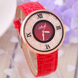 Detailed close-up of rose gold watch dial with crystals and red crocodile leather strap