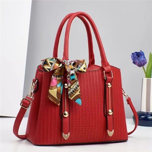 Elegant red multi-layer leather tote bag with geometric texture and decorative silk scarf