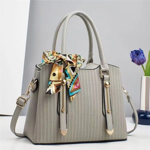 Minimalist light gray crossbody bag with lychee grain leather and colorful silk scarf