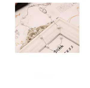 Detailed view of elegant multi-pearl necklace on decorative white frame background