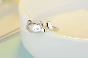 Macro shot of silver open cat ring with detailed feline ears and tail features
