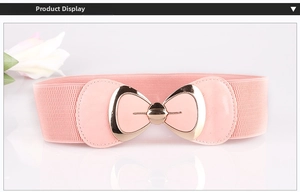 Detail of pink elastic waist belt featuring a gold bow buckle with matching pink inlay