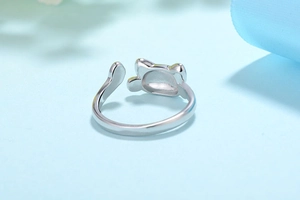Macro detail of silver adjustable cat ring showing polished inner band and cat ears