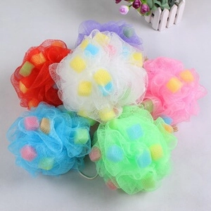Macro shot of colorful mesh loofahs with sponge cubes for deep cleaning and rich lathering