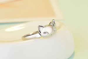 Macro shot of silver cat ring with sparkling cubic zirconia on ears and eyes