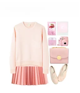 Flat lay of pink fashion set with sweater, pleated skirt, chain bag, and accessories