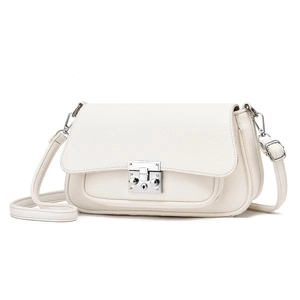 Detailed macro view of cream-colored litchi grain leather bag with silver buckle