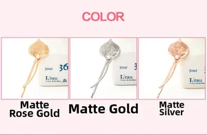 Close-up of matte gold, silver, and rose gold calla lily hair clips with white pearls