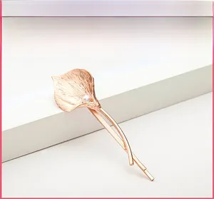 Detailed close-up of Calla Lily hair clip with brushed metal texture and pearl center