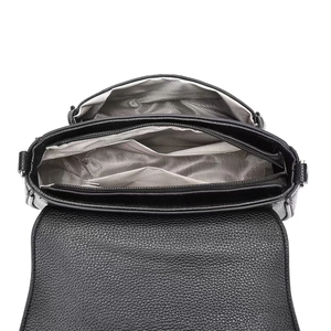 Top-view detail of black leather bag with multi-layer storage and grey lining