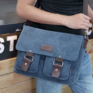 Vintage blue canvas messenger bag with brown leather accents and adjustable strap for men