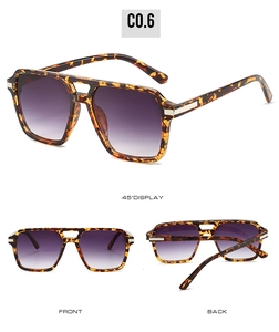 Detail view of tortoiseshell square sunglasses with purple gradient lenses and metal hinges
