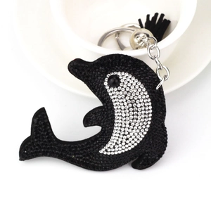 Detailed view of dolphin rhinestone keychain with black and silver crystals and fringe