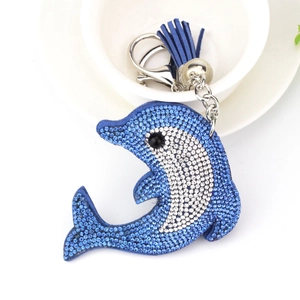 Detail of blue rhinestone dolphin keychain with leather tassel and silver bell accessory