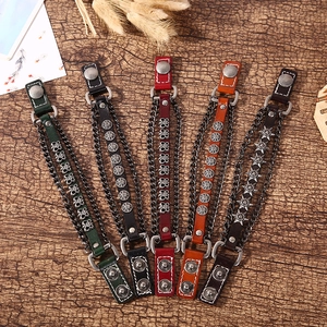 Detailed macro shot of five punk-style leather bracelets with metallic skull ornaments
