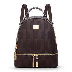Detailed close-up of dark brown checkered plaid backpack featuring golden hardware