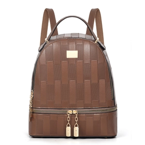 Close-up of brown synthetic leather backpack featuring 3D square texture and gold hardware
