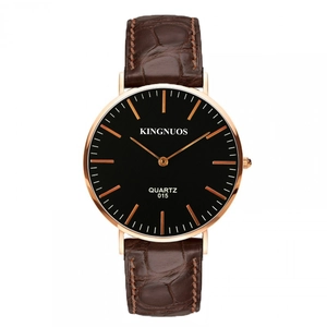 Detail of rose gold quartz watch with black dial and brown crocodile leather strap