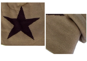 Detail shot of khaki knit beanie featuring a black star pattern and textured wool material