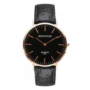 Detail of KINGNUOS quartz watch with rose gold case and black crocodile pattern leather strap