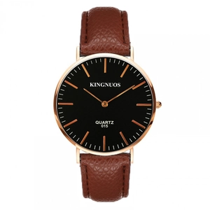 Macro detail of brown leather strap and rose gold case on a quartz wristwatch