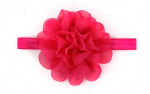 Macro detail of magenta handmade chiffon flower on elastic baby headband hair accessory