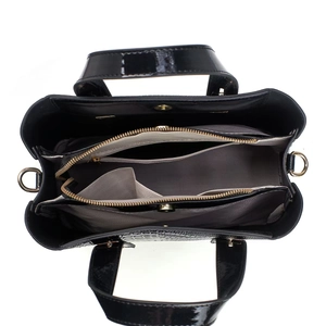 Top view of black patent leather handbag showing organized multi-layer interior compartments
