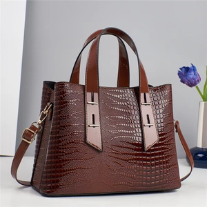 Dark brown crocodile embossed handbag with gold hardware and removable shoulder strap