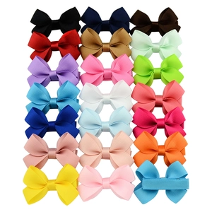 Matrix of colorful grosgrain ribbon bow hair clips for kids on white background