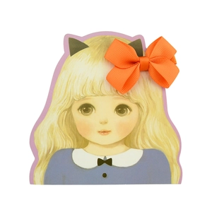 Detail of cute cartoon girl hair accessory card featuring a bright orange ribbon bow