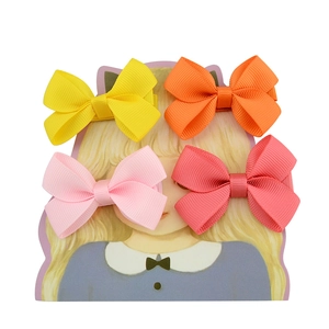 Set of four colorful grosgrain ribbon bow hair clips for children on display card