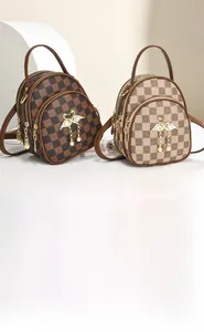 Detail of checkered pattern mini backpack with golden swan pendant and faux leather texture