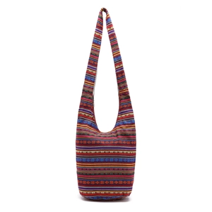 Detail of bohemian colorful striped canvas hobo bag with ethnic tribal pattern