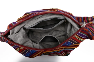 Interior detail of ethnic canvas bucket bag showing zipper pocket and striped pattern