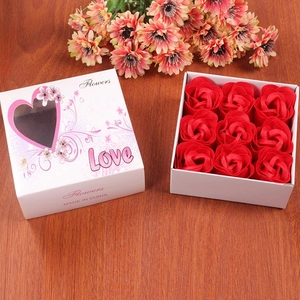 Detailed view of nine red soap roses in a white gift box with heart-shaped window