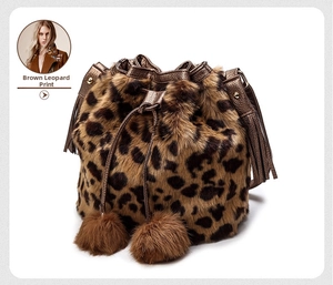 Detailed close-up of brown leopard print faux fur bucket bag with tassels and plush pom-poms