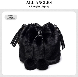 Close-up of black faux fur bucket bag with drawstring closure and soft plush pompom detail