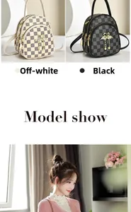 Close-up of checkered mini backpacks in cream and black with swan pendants