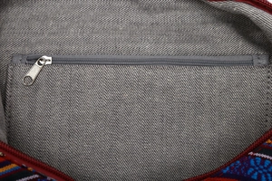 Detail view of ethnic bucket bag featuring grey twill lining and internal zipper pocket