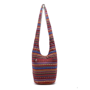 Detailed view of colorful ethnic striped patterns and front zipper on linen crossbody bag