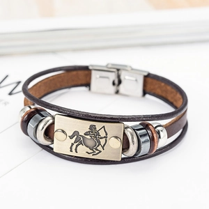 Detail of vintage Sagittarius leather bracelet with bronze zodiac plate and metal buckle