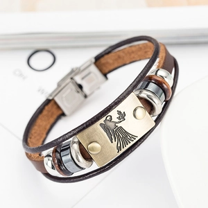 Detail view of woven brown leather bracelet with bronze Virgo zodiac sign metal plate