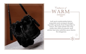 Detail of black faux fur bucket bag featuring a long leather tassel and soft texture