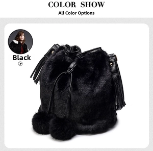 Close-up of black faux fur bucket bag with plush pom-poms and leather drawstring details