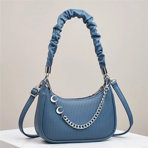 Blue half-moon leather shoulder bag with pleated handle and silver moon chain charms