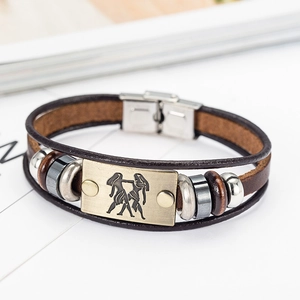 Detail of Gemini leather bracelet with bronze zodiac plate and silver metal clasp