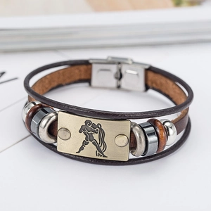 Detail of brown braided leather bracelet with bronze Aquarius zodiac sign metal plate