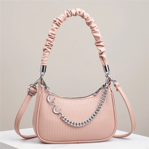 Detailed view of pink moon bag featuring embossed leather texture and silver chain accents