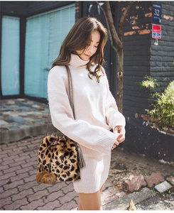 Detailed view of leopard print faux fur bucket bag with chain strap on a model